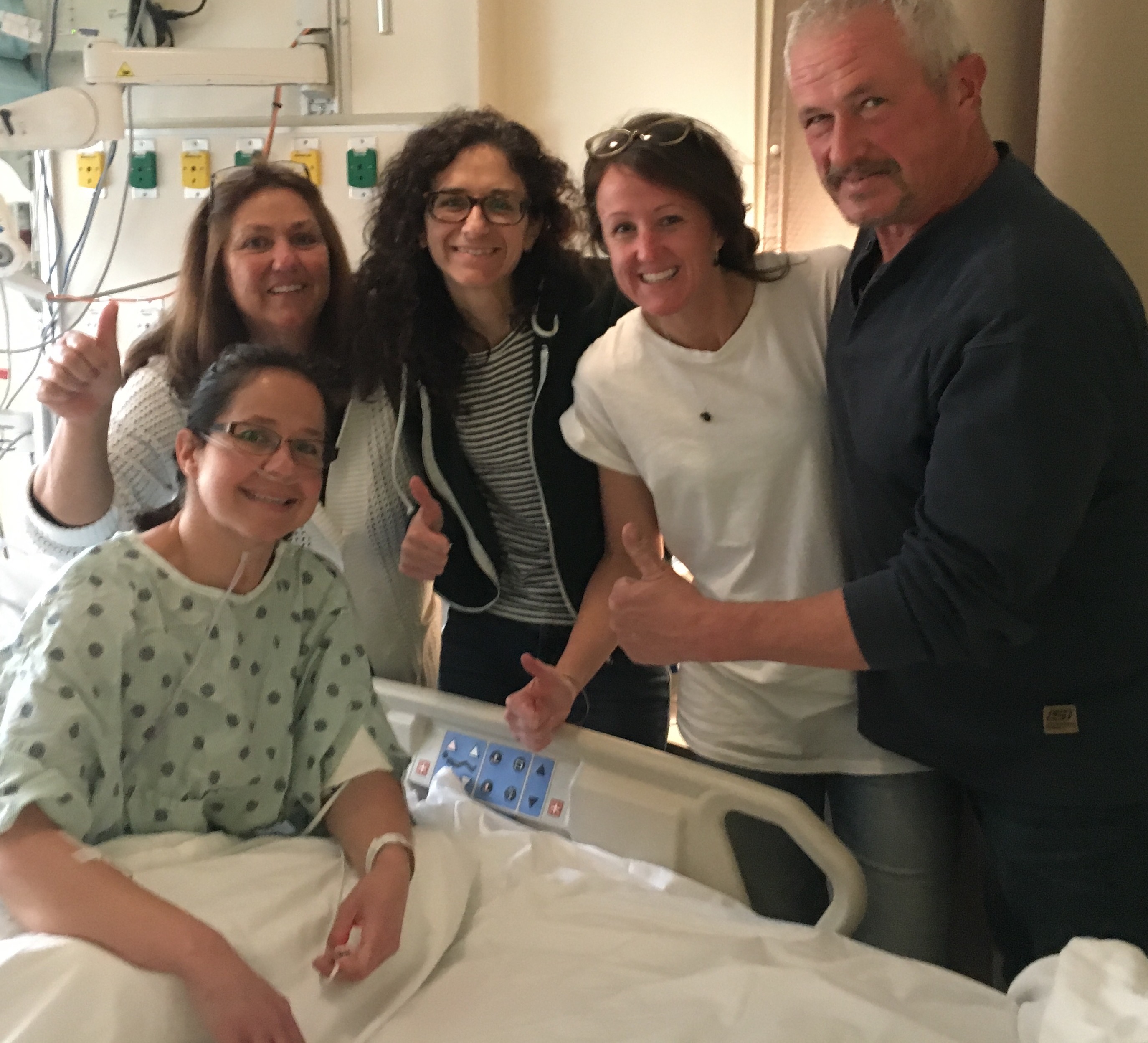 Erika Todd with family around a hospital bed
